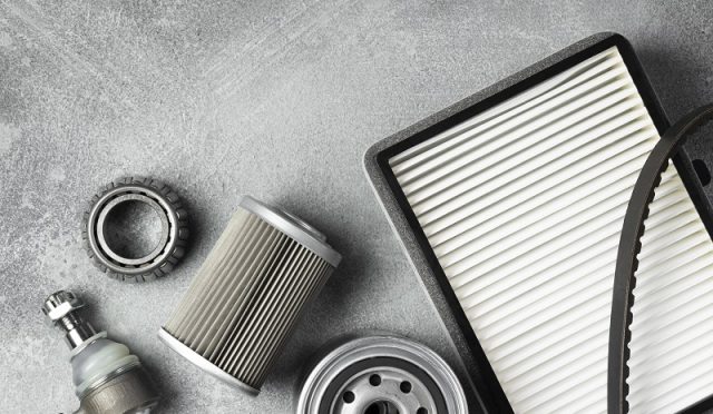 Top view of different car parts isolated on gray background with copy space